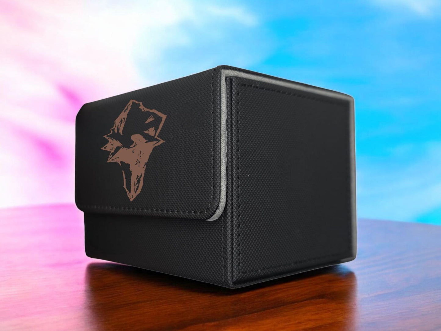 a black box sitting on top of a wooden table