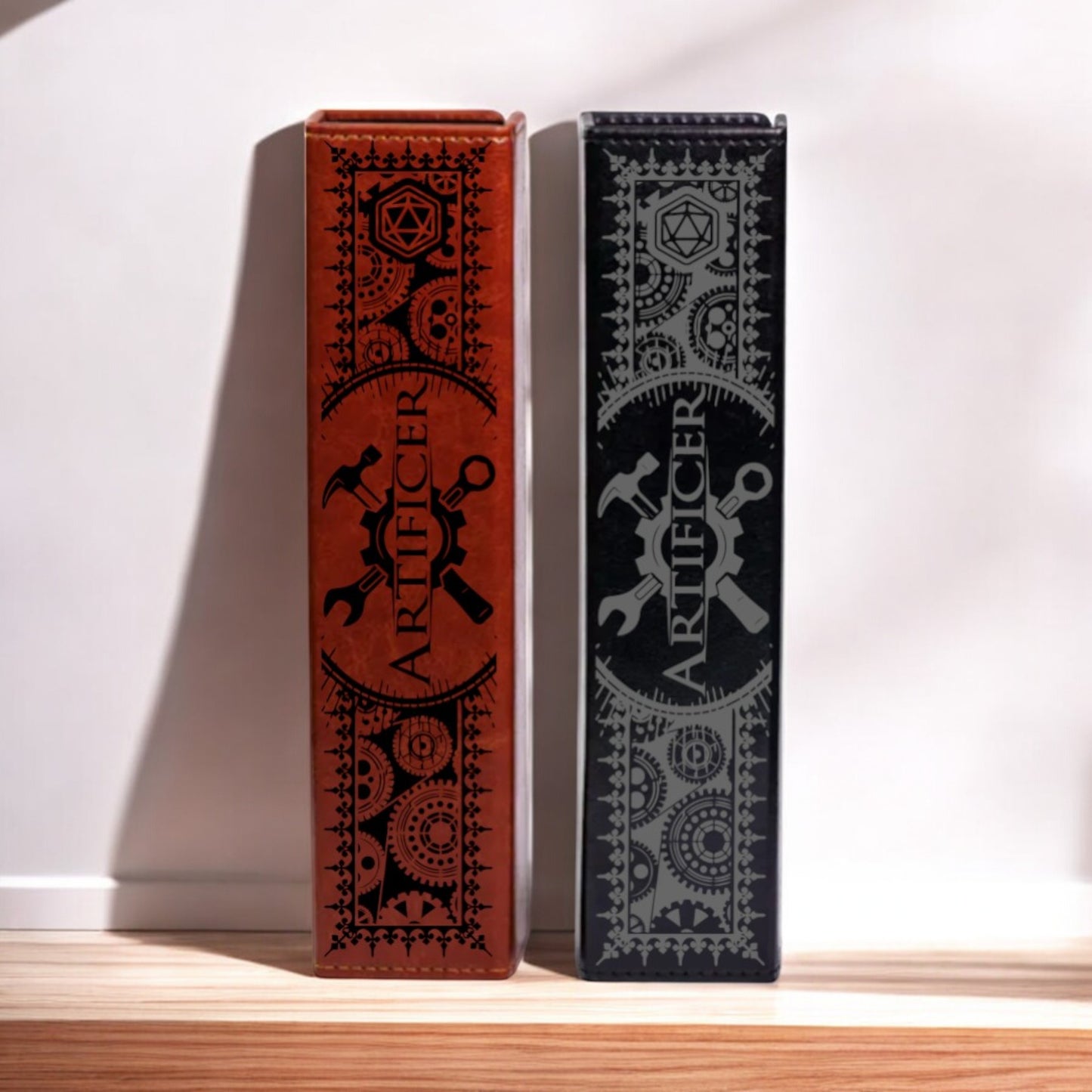 Two tall, narrow boxes with intricate designs and text on them, standing upright on a wooden surface.