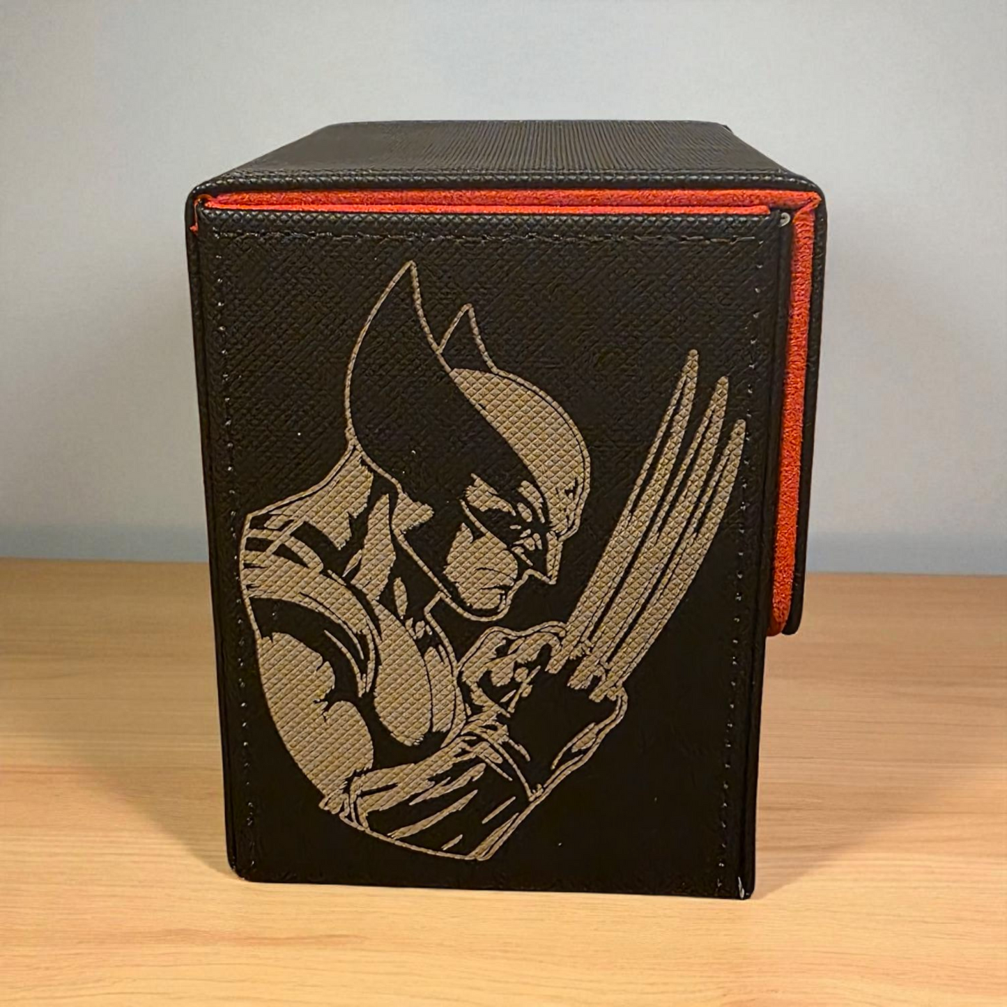 A black and red storage box with a graphic of a superhero character on the front.