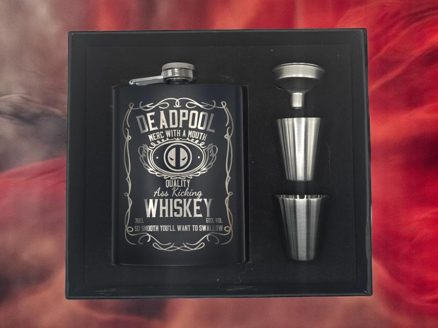 a flask and a shot glass in a box