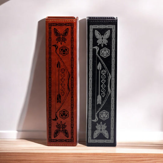 Two ornate, decorative bookends with intricate designs and patterns on their sides stand side by side against a white wall.