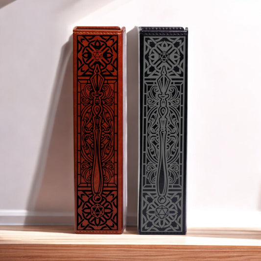 Two ornate, decorative boxes with intricate patterns and designs, one in red and one in black, standing upright on a wooden surface against a white background.