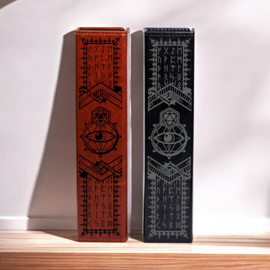 Two leather-bound books with intricate designs and text on their covers stand upright on a wooden surface.