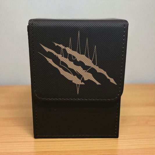 A black leather wallet or card holder with a metallic design on the front.