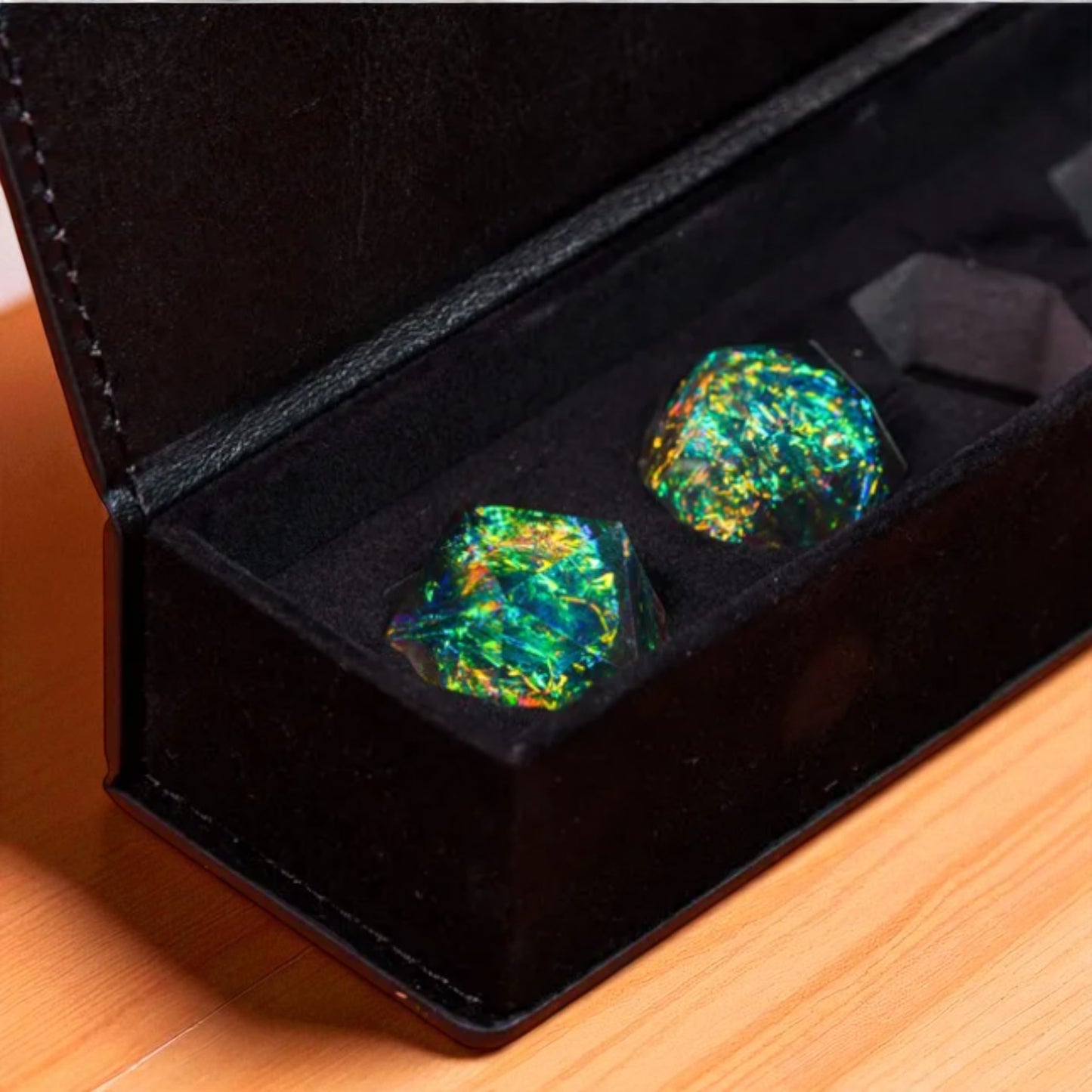 A black box containing two colorful, hexagonal-shaped objects with a vibrant, iridescent appearance.