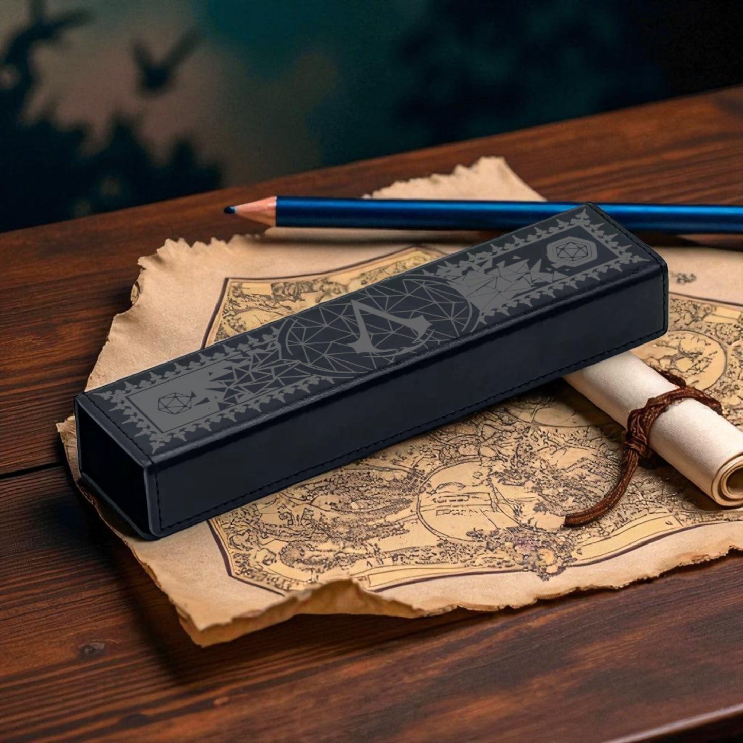 A black pencil case with a map of a fantasy world on it, along with a rolled-up parchment and a blue pencil, all resting on a wooden surface.