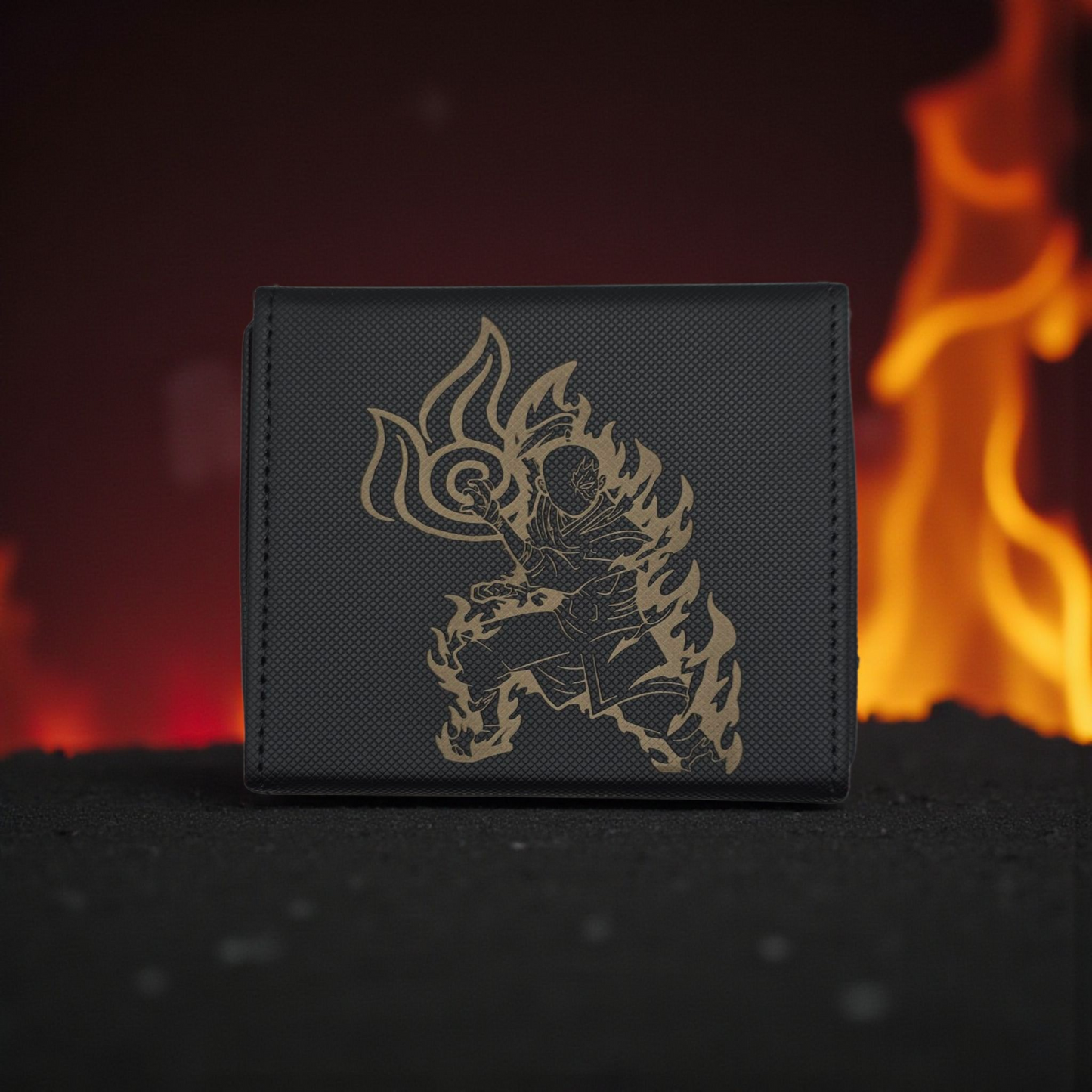 A black wallet with a gold-colored design depicting a stylized figure with flames on it, placed against a background of a blurred fire.