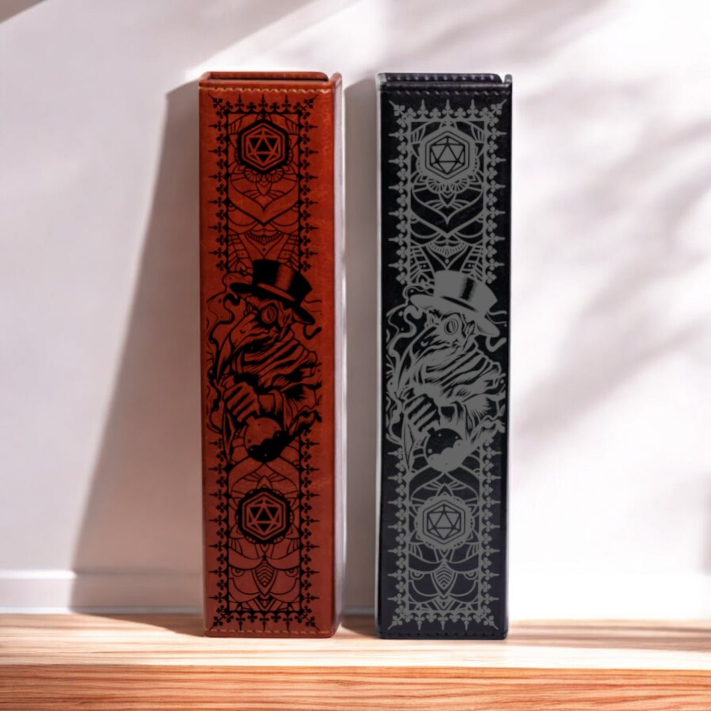 Two leather-bound books with intricate designs on their covers are displayed side by side on a wooden surface.