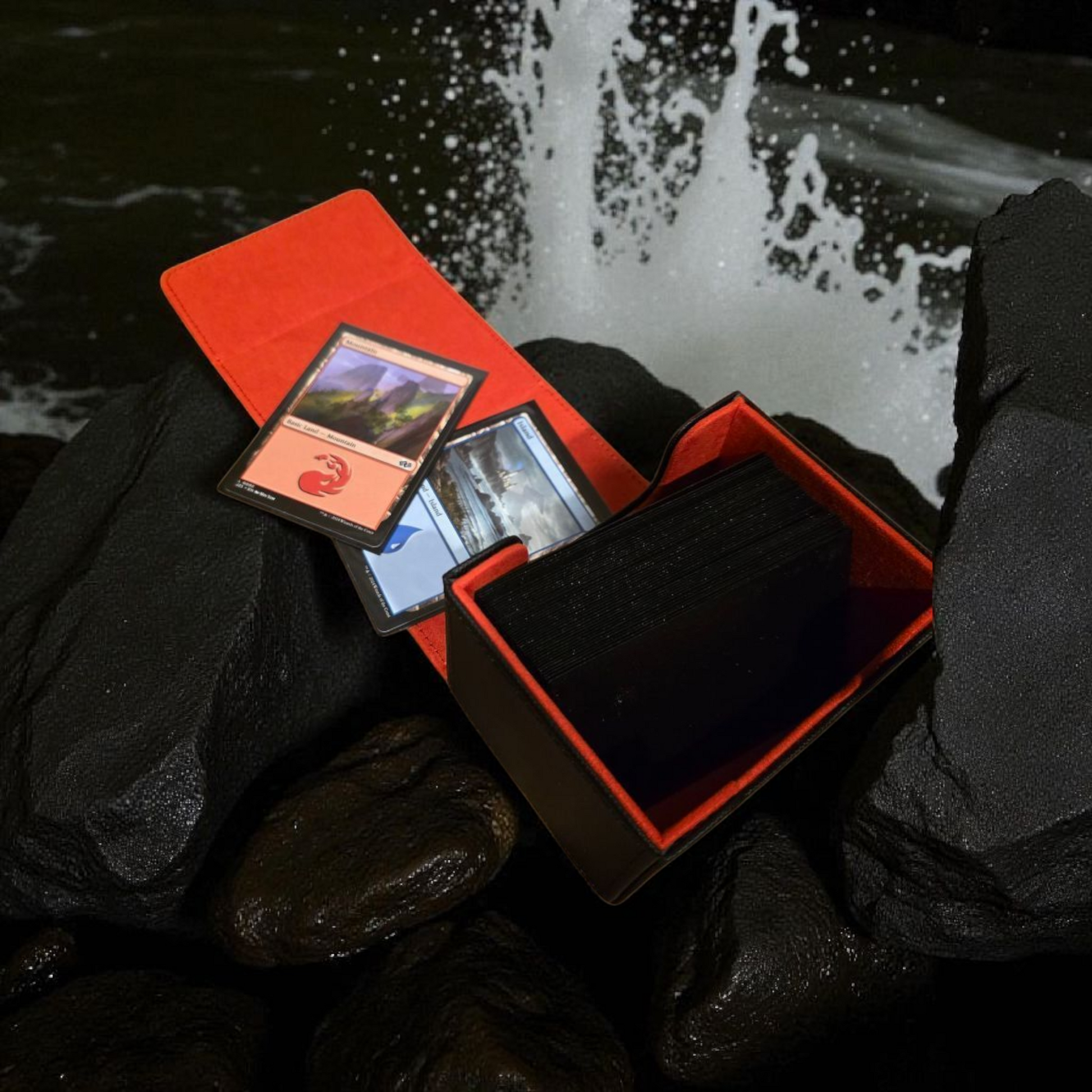 A red Magic: the Gathering card deck is shown, with the deck open and the cards visible, set against a backdrop of a waterfall and rocks.