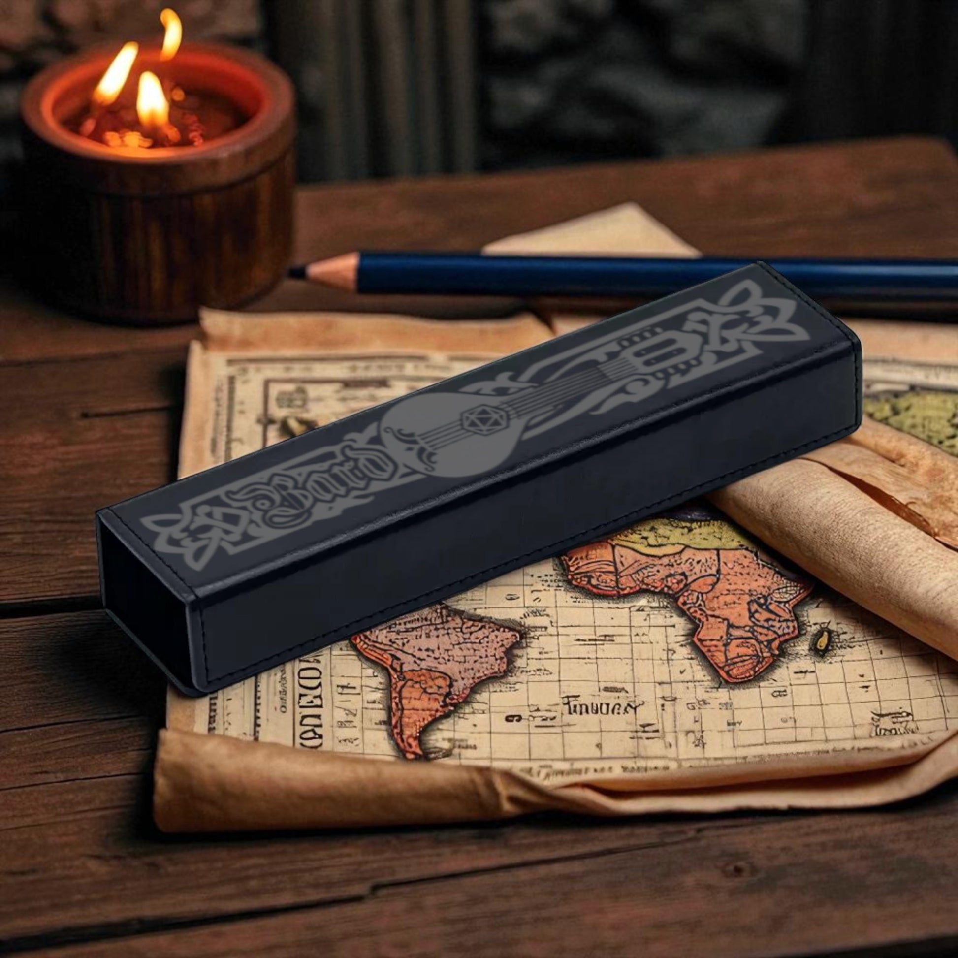 a black pencil case with a guitar design, placed on top of a map of the world, with a lit candle in the background.