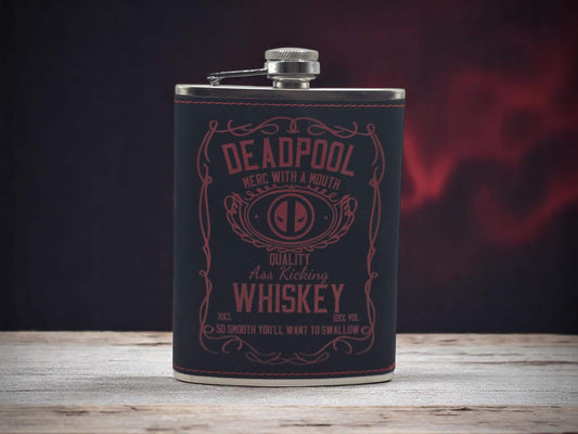 a flask of deadpool whiskey on a wooden table
