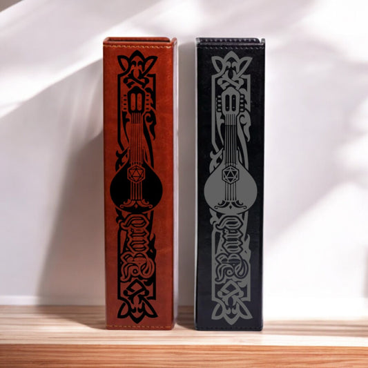 Two tall, narrow, rectangular leather-bound books with decorative patterns on their spines are standing side by side against a white wall.