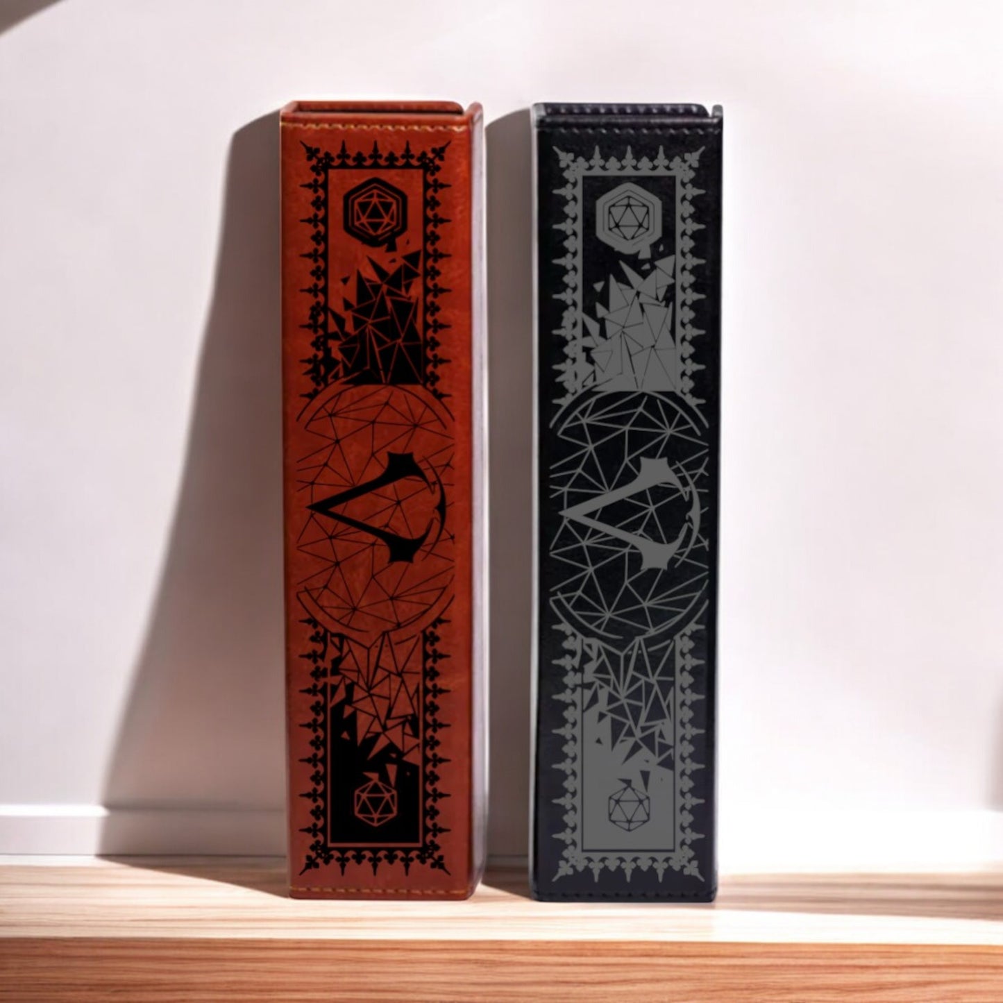 Two leather-bound books with intricate geometric designs on their covers stand upright on a wooden surface.