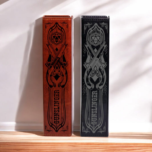 Two leather-bound books with ornate designs and text on their covers are standing upright on a wooden surface.