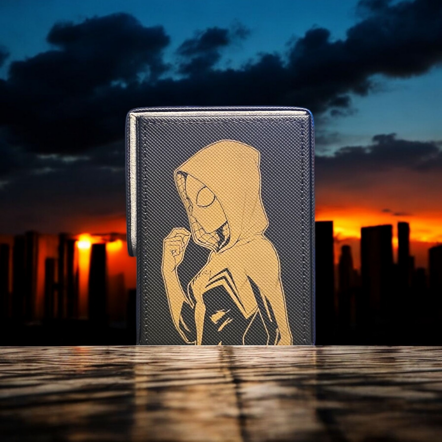 A wallet or card case with a printed image of Spider-Man on it, set against a backdrop of a city skyline at sunset.
