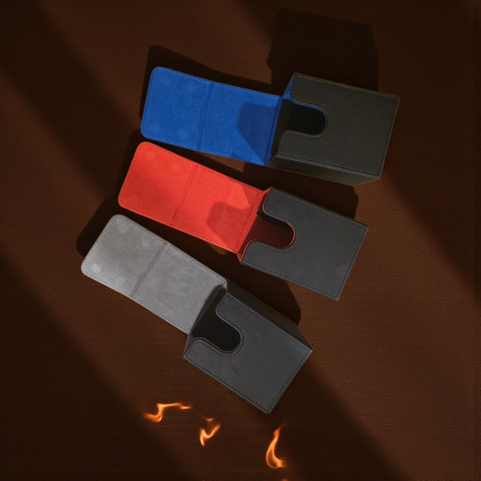 three different colored wallet cards, including a blue wallet, a red wallet, and a black wallet, arranged on a brown surface.