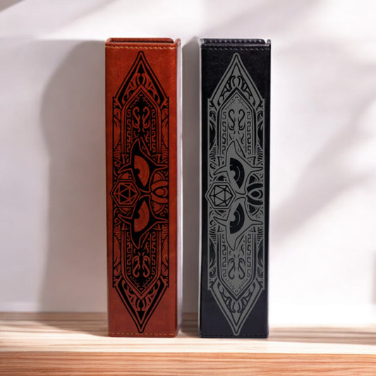 Two tall, rectangular boxes with intricate, decorative designs on their sides are standing side by side against a white wall.